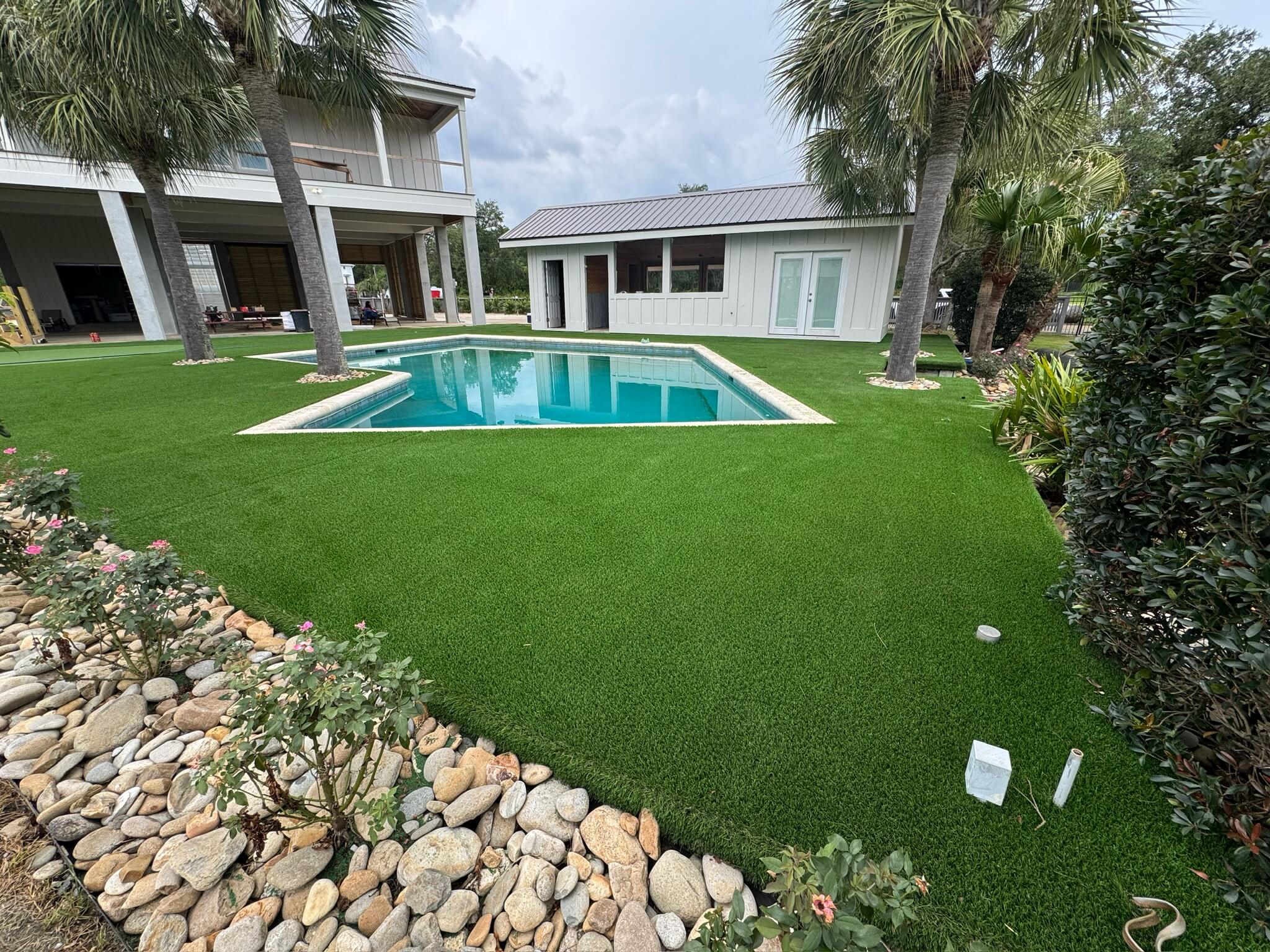 A swimming pool with turf installed around it